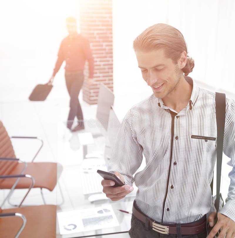 Employee reads a text message on smartphone royalty free stock photos