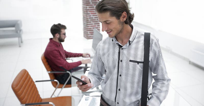 Employee reads a text message on smartphone royalty free stock images