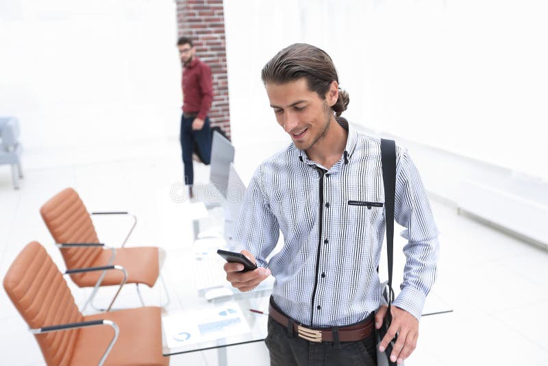 Employee reads a text message on smartphone royalty free stock images