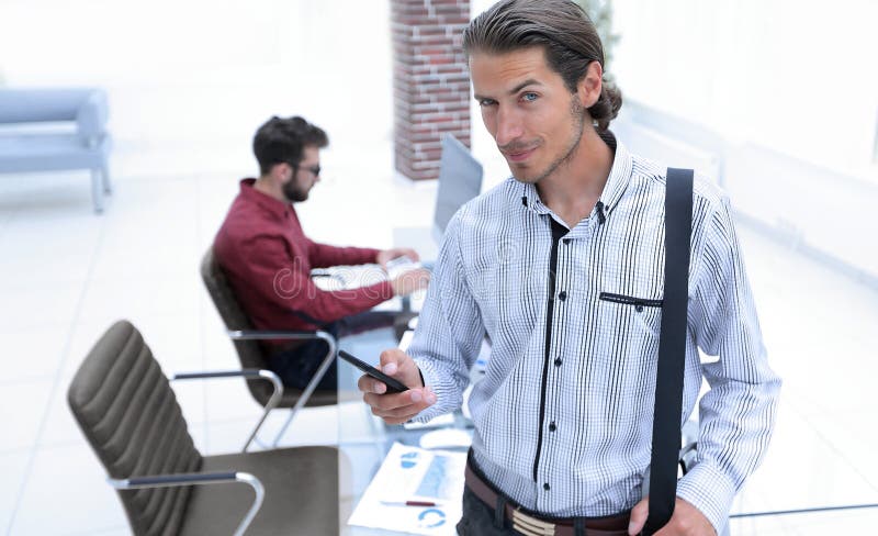 Employee reads a text message on smartphone royalty free stock photo