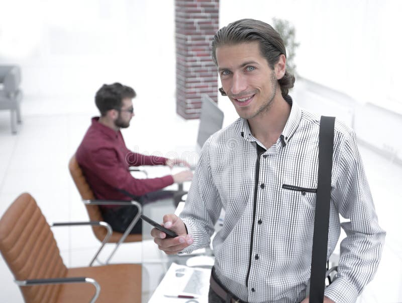 Employee reads a text message on smartphone royalty free stock photography