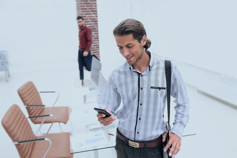 Employee reads a text message on smartphone stock images