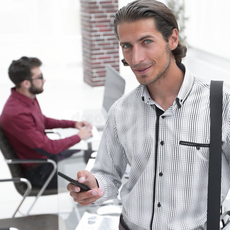 Employee reads a text message on smartphone stock photo