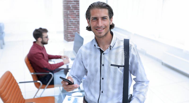 Employee reads a text message on smartphone stock images