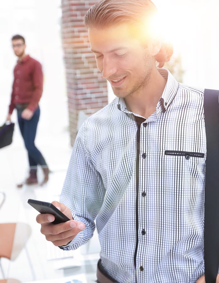 Employee reads a text message on smartphone royalty free stock photo