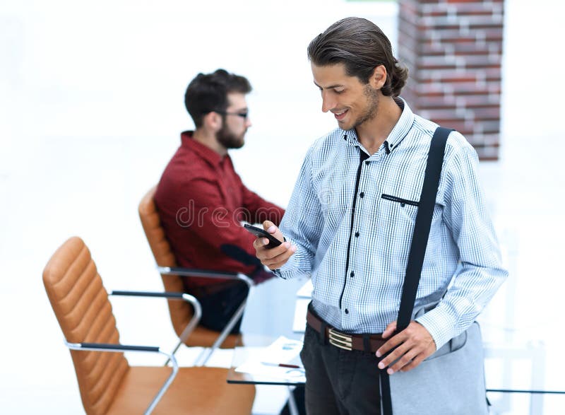 Employee reads a text message on smartphone royalty free stock image