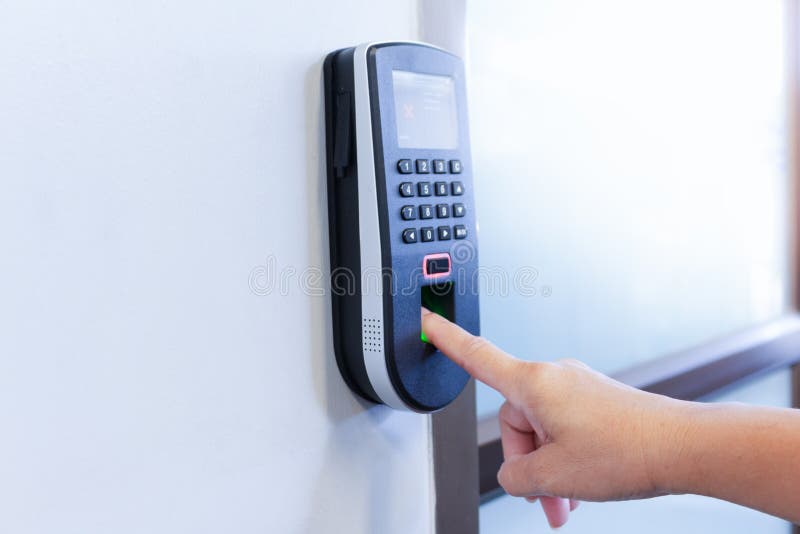 Employee scanning fingerprint to record working time stock photos