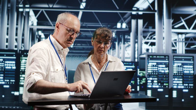 Employees crosschecking server parts stock images
