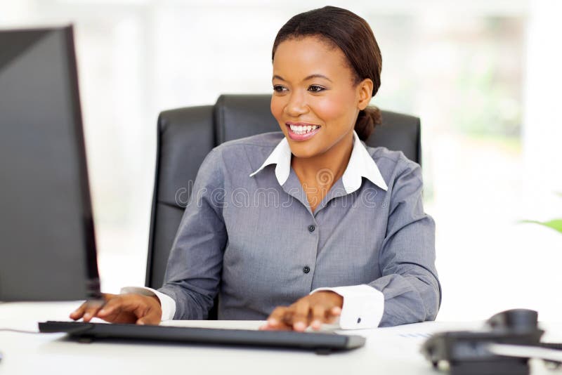 Beautiful young african american office worker working on computer. Beautiful young african american office worker working on computer