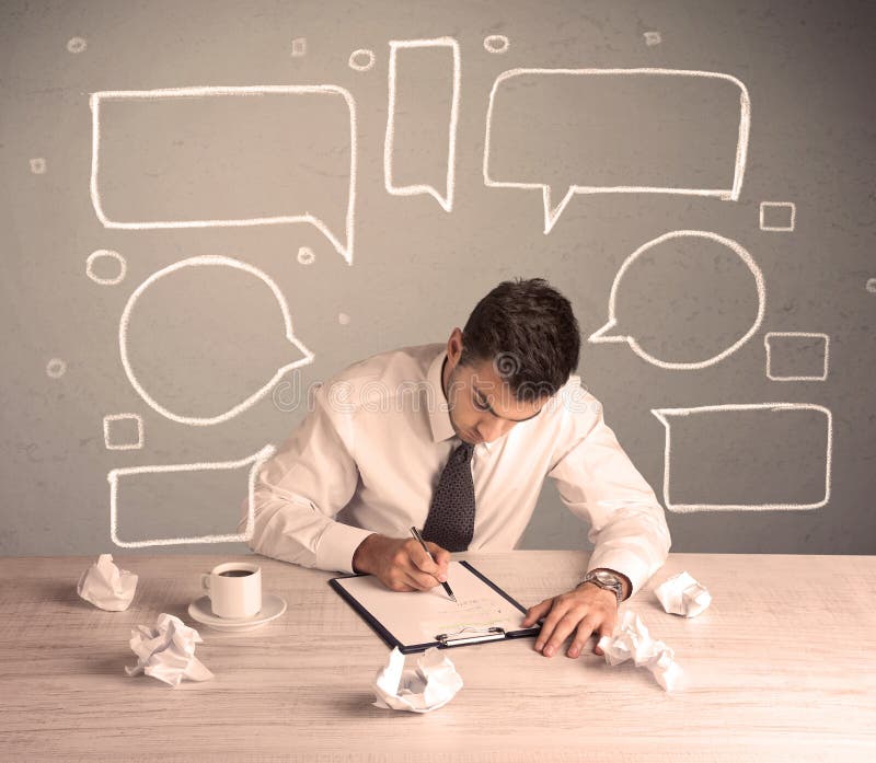 An intelligent elegant business person sitting at a desk and working with drawn empty text bubbles, boxes around him concept. An intelligent elegant business person sitting at a desk and working with drawn empty text bubbles, boxes around him concept