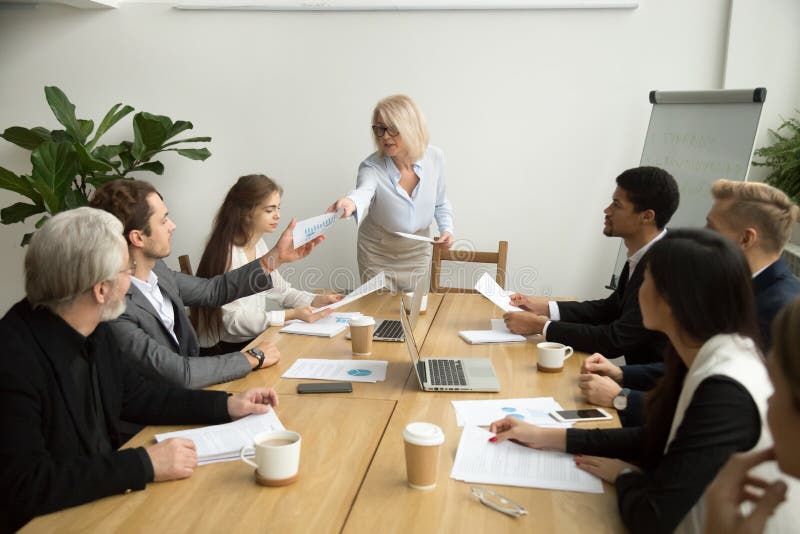 Empresaria mayor que da informe financiero al encargado en el equipo imágenes de archivo libres de regalías Empresaria mayor que da informe financiero al encargado en el equipo imágenes de archivo libres de regalías