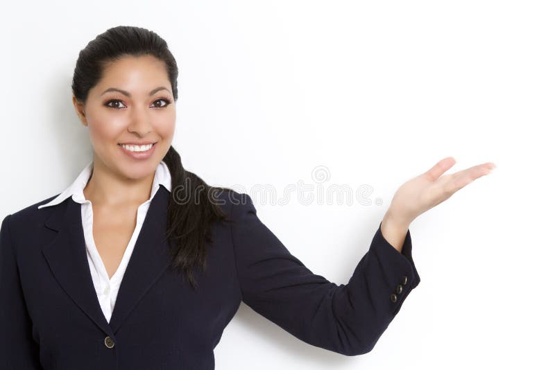 Smiling young businesswoman referrring to negative copy space for type or diagram. Smiling young businesswoman referrring to negative copy space for type or diagram