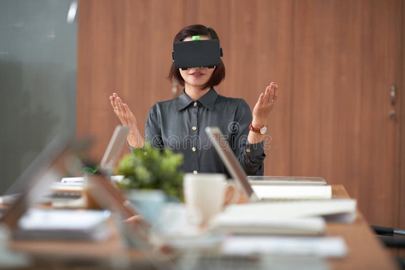 Empresaria que se sienta en la reunión de negocios virtual imagenes de archivo