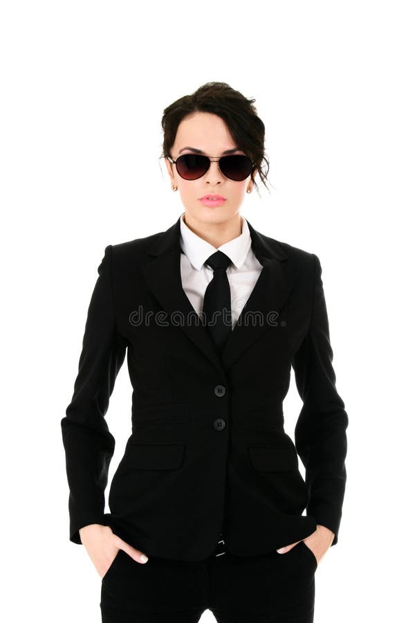 Serious businesswoman in black glasses holding hands in pockets isolated on white background. Serious businesswoman in black glasses holding hands in pockets isolated on white background