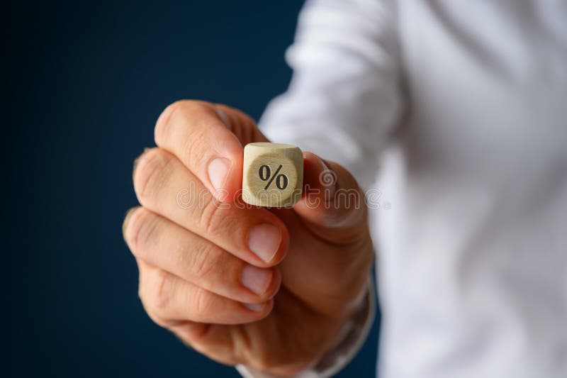 Empresario sosteniendo dados dados de madera con signo % imagen de archivo libre de regalías Empresario sosteniendo dados dados de madera con signo % imagen de archivo libre de regalías