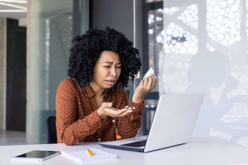 Distressed businesswoman seeking professional help through an online consultation with a psychotherapist, visibly upset and wiping tears. Distressed businesswoman seeking professional help through an online consultation with a psychotherapist, visibly upset and wiping tears.