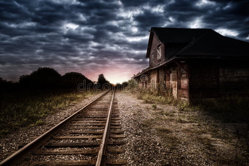Empty and abandoned train station at night, sunset in background. Night train stock images, royalty-free photos and pictures
