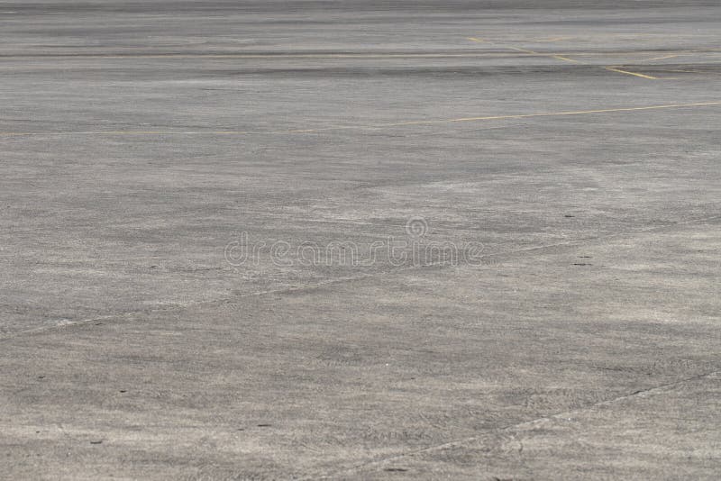 Empty asphalt airport space. Grunge asphalt perspective photo. Sunny faded grey asphalt background.