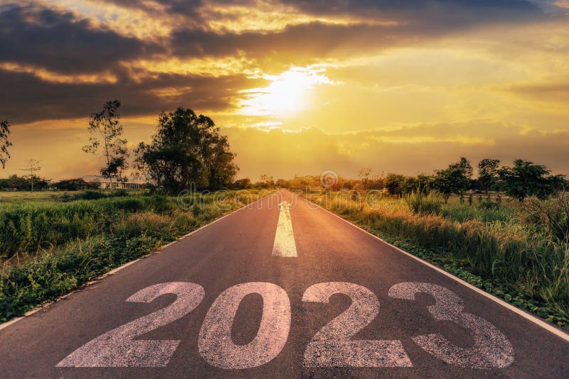 Empty asphalt road and New year 2023 concept. Driving on an empty road to Goals 2023 with sunset