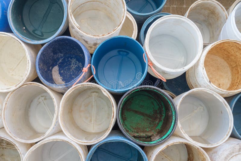 Empty barrels ready for loading of fresh bait on a working dock stock photo