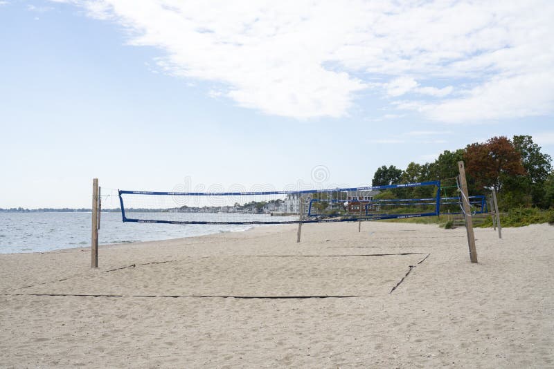Empty Beach with Volleyball Nets Set Up for Playing. Houses Along the