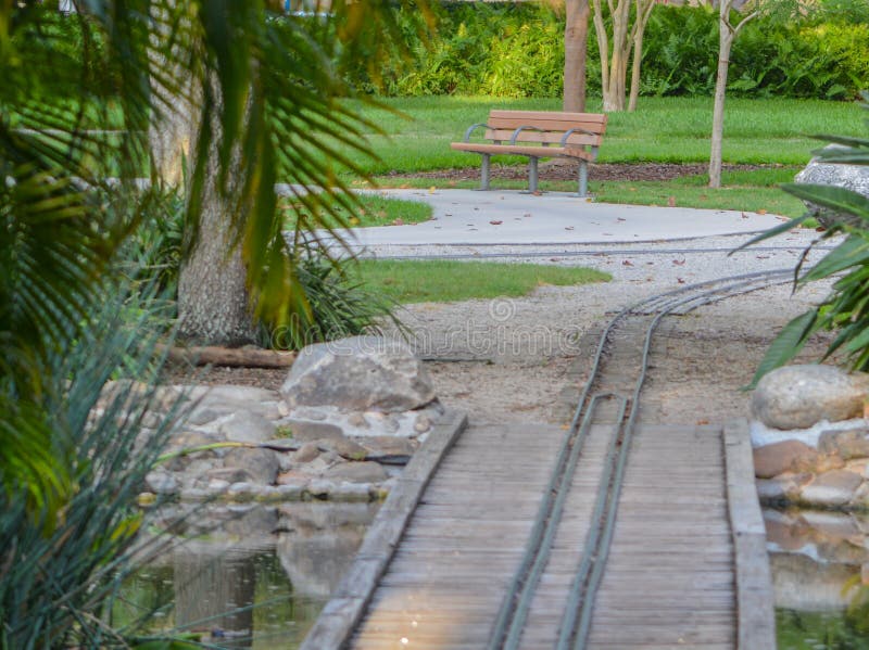 Empty bench and kids train track in Largo Central Park in Largo, Florida, USA