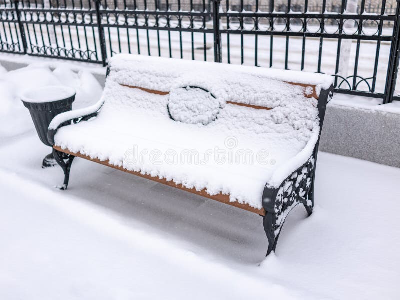 Empty bench in the winter park covered with fresh white snow royalty free stock images Empty bench in the winter park covered with fresh white snow royalty free stock images