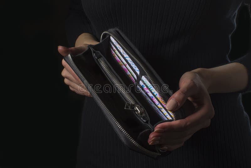 Empty black wallet purse in female hands.Wallet.