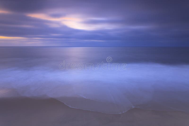 Empty blue beach at sunset