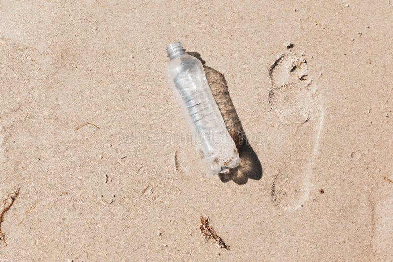 Ecological foot print symbol image with plastic waste on ocean b