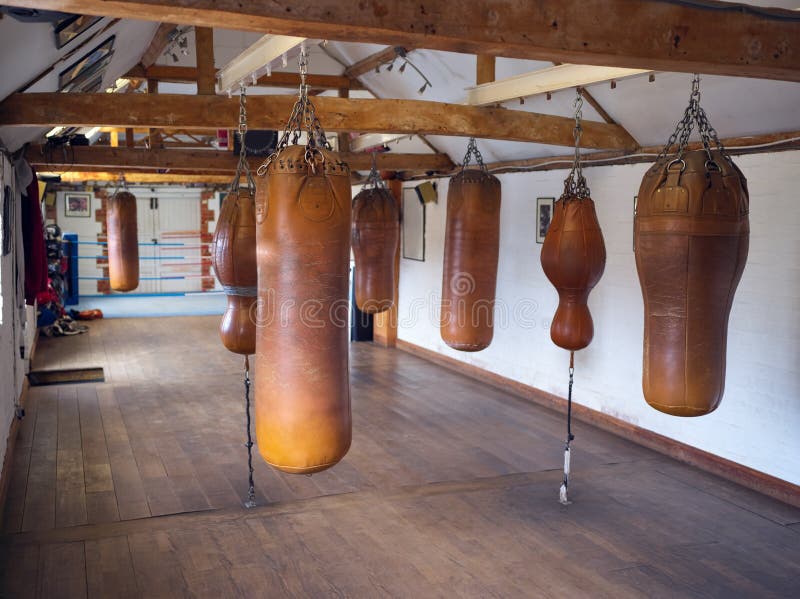 Empty Boxing Training Gym With Old Fashioned Leather Punch Bags