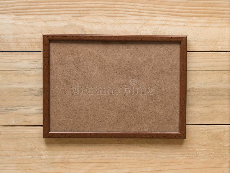 Empty brown wooden photo frame on light brown wooden wall. Mock up royalty free stock images Empty brown wooden photo frame on light brown wooden wall. Mock up royalty free stock images
