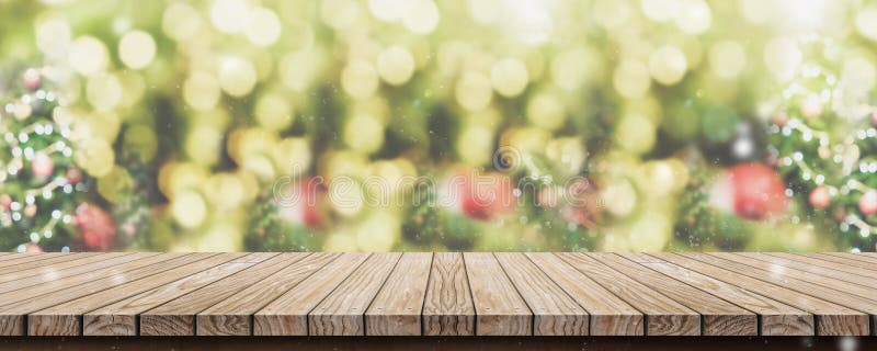 Empty brown wooden table top with abstract green blur christmas