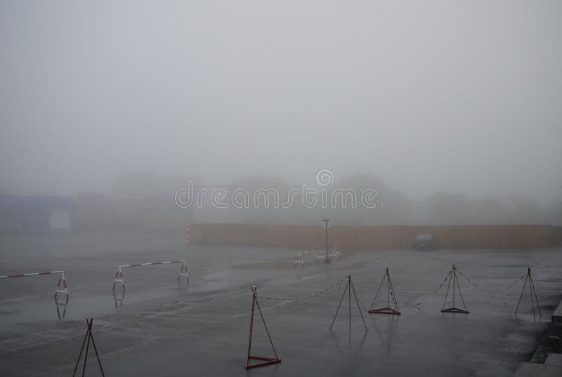 Empty car parking in the fog stock photos Empty car parking in the fog stock photos