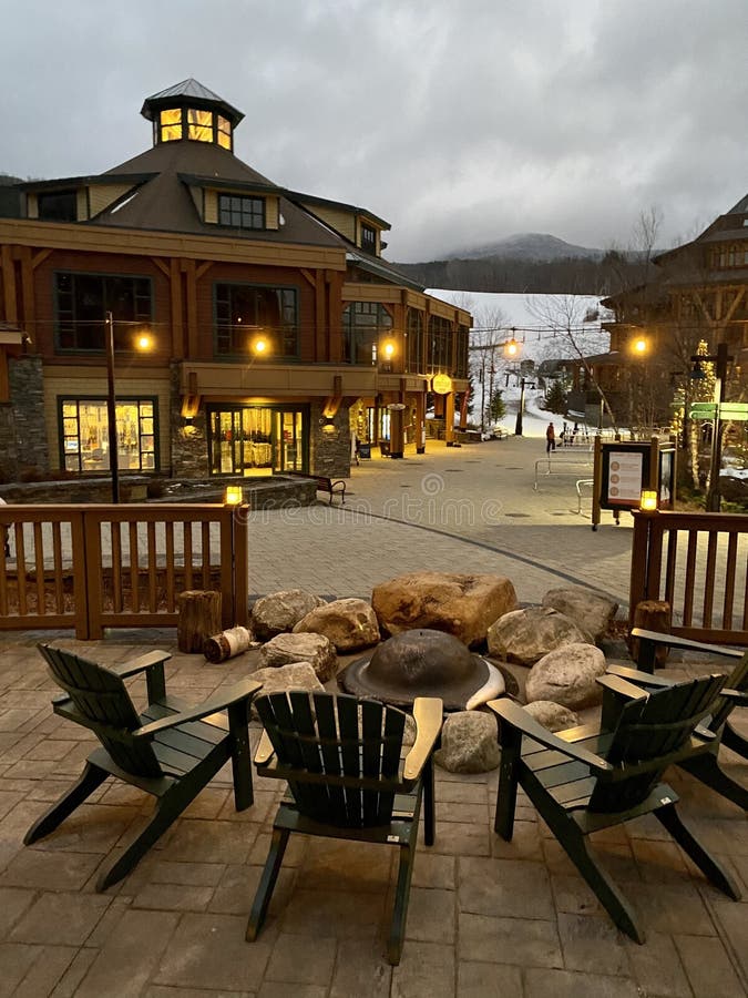 Empty chairs and fire ring at Stowe Mountain resort Spruce peak village