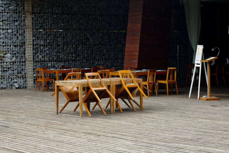 Empty Chairs and Tables at Closed Outdoor Restaurant Stock Photo