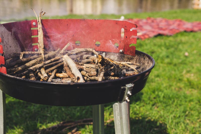 Empty Charcoal Grill with Smoke Closeup. Barbecue Outdoor. Stock Photo