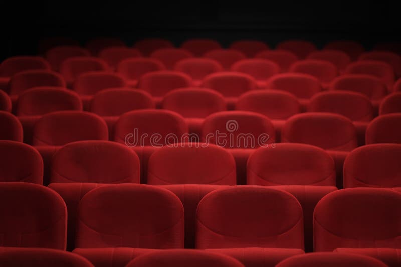 Empty cinema hall with red seats. Movie theatre.