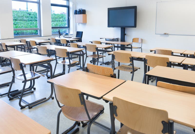 Empty classroom with tables and chairs