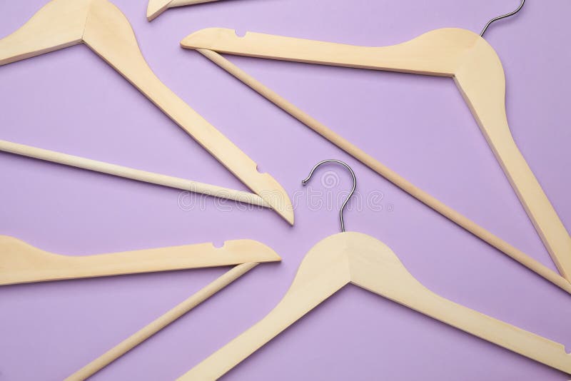 Empty Clothes Hanger on Violet Background, Top View. Space for Text