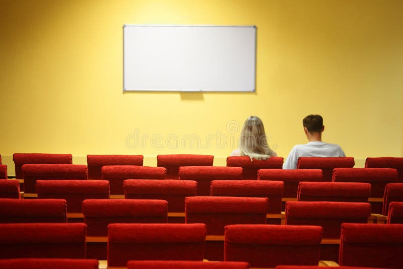 Empty conference hall. couple sitting in chairs