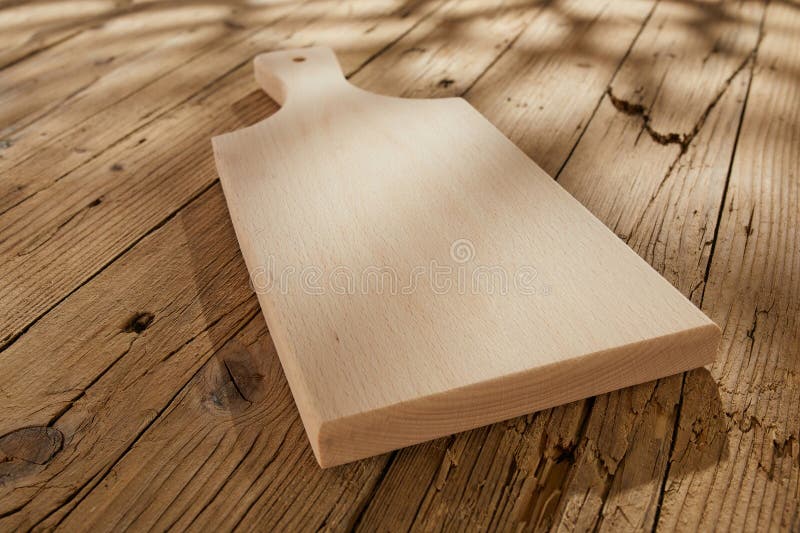 Empty Cutting Board on an Old Wooden Surface with Cracks. Background