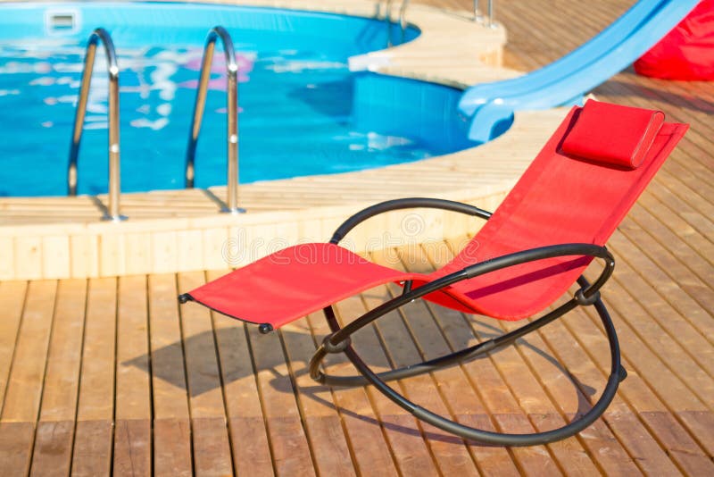 Empty deckchair near pool stock photo. Image of pool 32483208