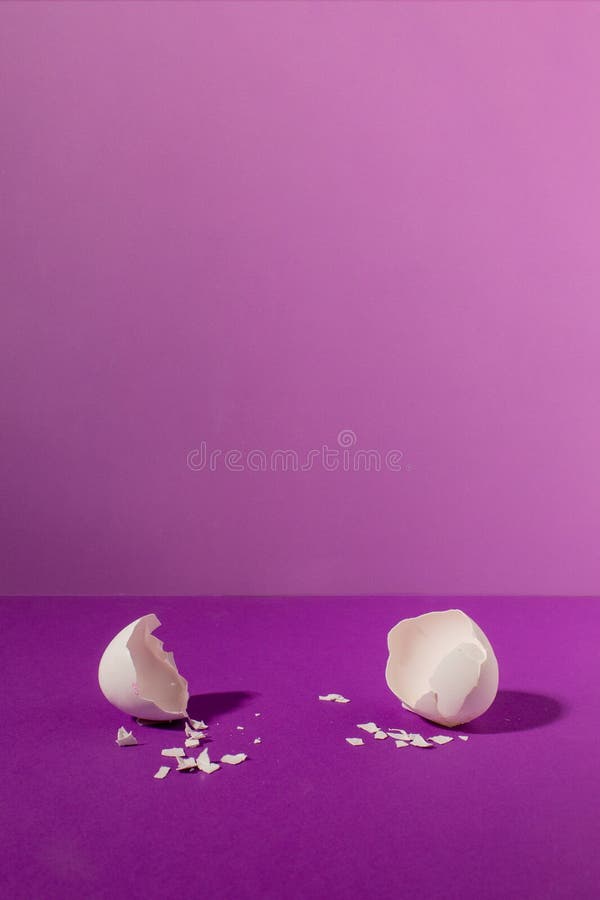 Empty eggshell with creative copy space on pastel purple background. Minimal Easter holiday concept royalty free stock image