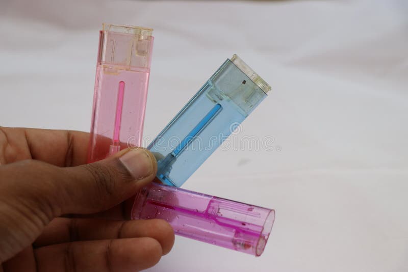 Empty fire lighter with all disassembled parts held in hand royalty free stock image