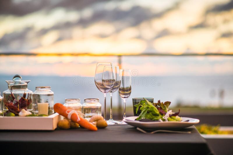 Empty glasses set in restaurant - Dinner table outdoors at sunset
