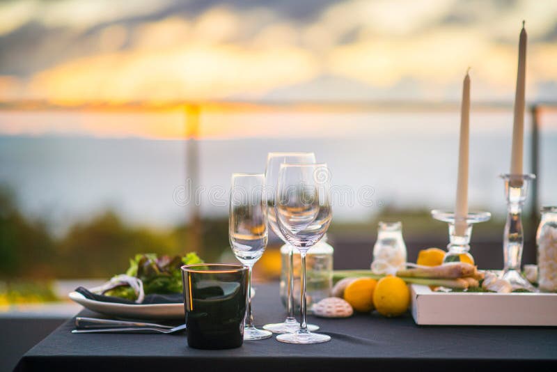 Empty glasses set in restaurant - Dinner table outdoors at sunset