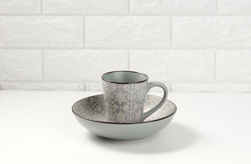 Empty Gray Ceramic Soup Plate and Empty Cup on White Table, Utensils