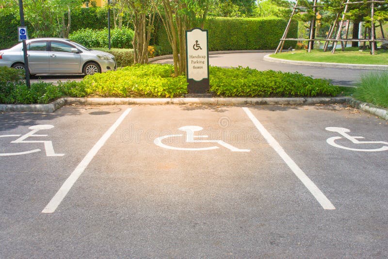 Empty handicap parking areas in parking lot reserved for disabled people at outdoor. stock photo Empty handicap parking areas in parking lot reserved for disabled people at outdoor. stock photo