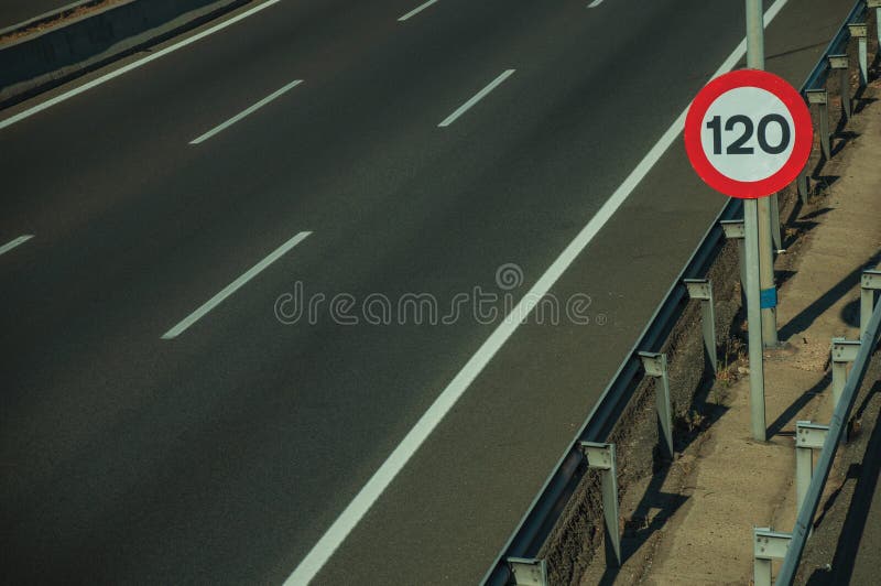 Empty highway with SPEED LIMIT signpost in Madrid